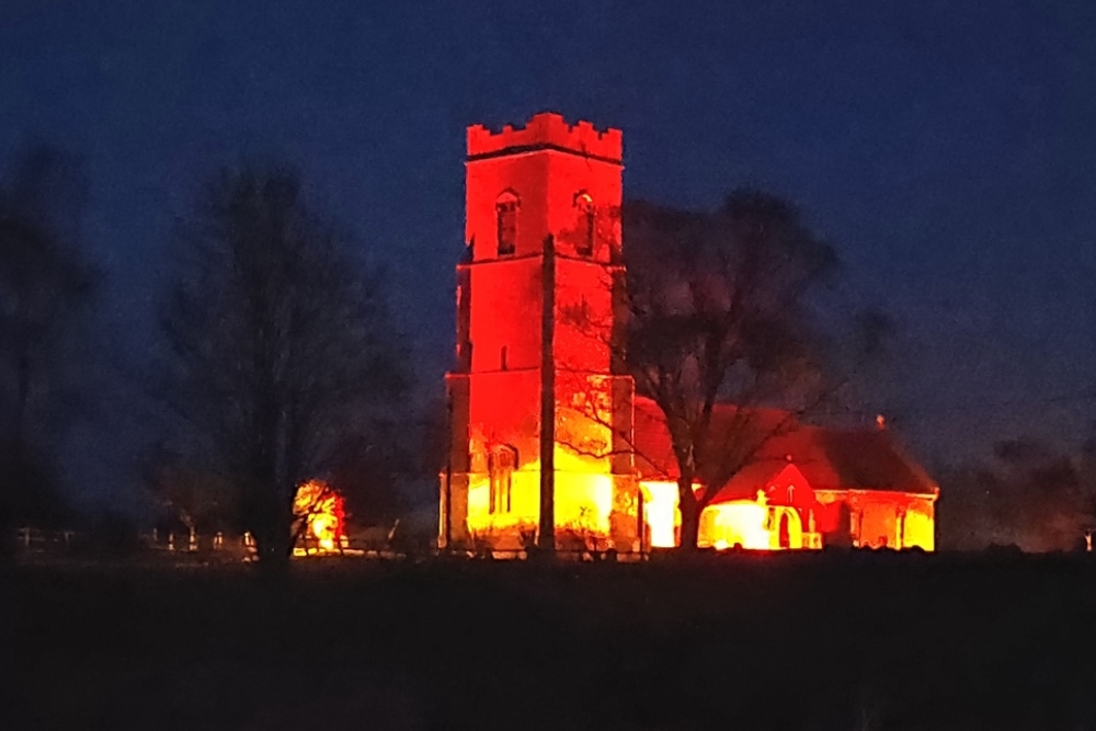 Snape Church illuminated, A1094 protests!
